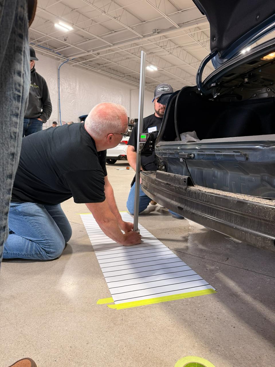 ADAS Blind Spot Aiming Tool Kit set up with measuring mat and digital angle guide for sensor calibration